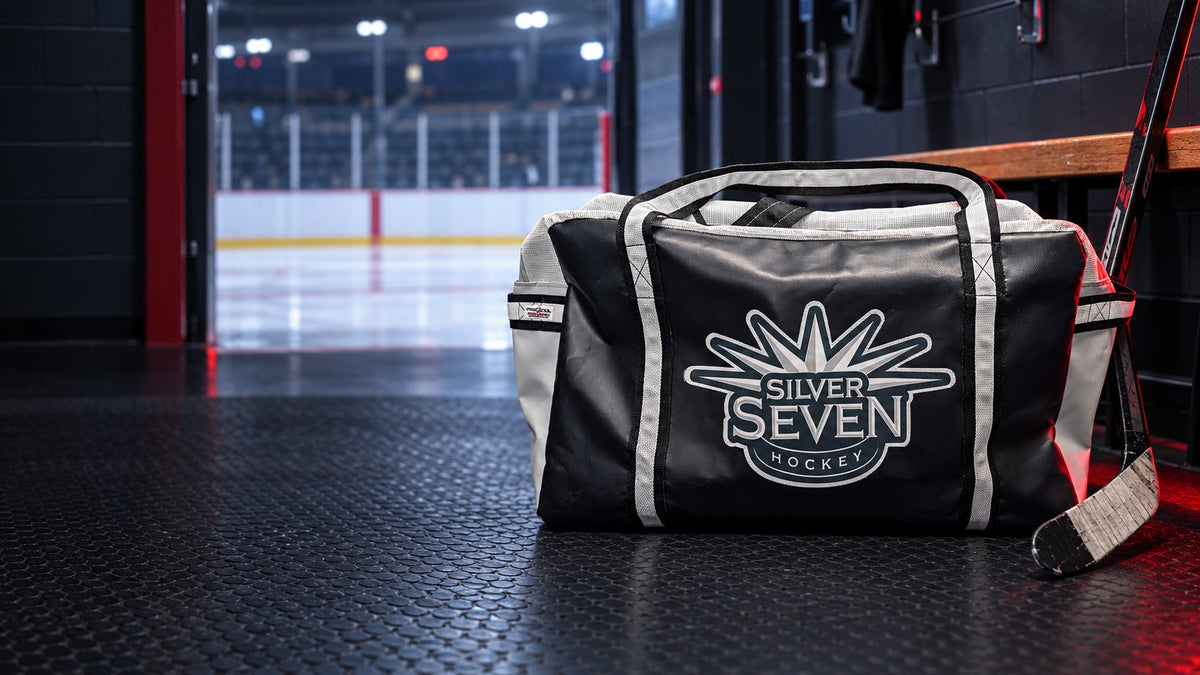 Custom Silver Seven hockey bag in an arena dressing room